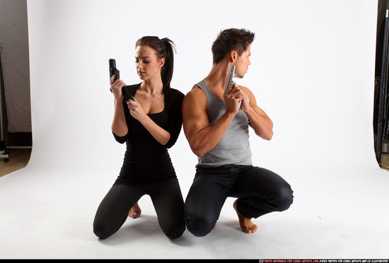 Man & Woman Adult Athletic White Fighting with gun Kneeling poses Casual