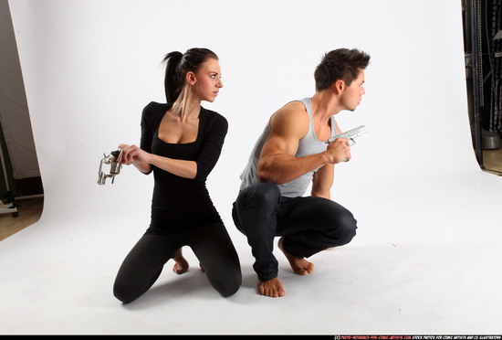 Man & Woman Adult Athletic White Fighting with gun Kneeling poses Casual