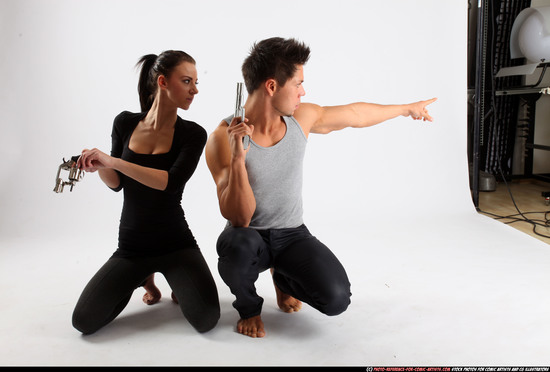 Man & Woman Adult Athletic White Fighting with gun Kneeling poses Casual