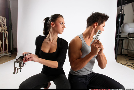 Man & Woman Adult Athletic White Fighting with gun Kneeling poses Casual