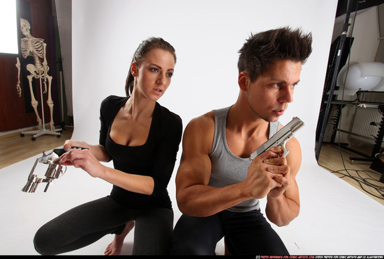 Man & Woman Adult Athletic White Fighting with gun Kneeling poses Casual