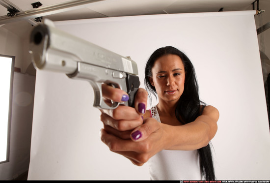 Woman Young Athletic Fighting with gun Standing poses Casual Latino