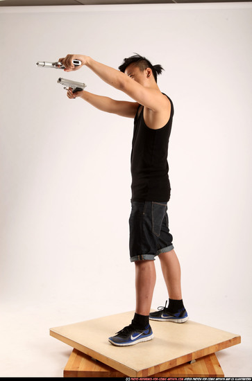 Man Young Athletic Fighting with gun Standing poses Casual Asian