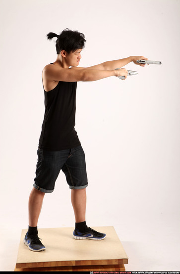 Man Young Athletic Fighting with gun Standing poses Casual Asian