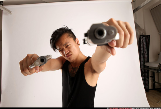 Man Young Athletic Fighting with gun Standing poses Casual Asian