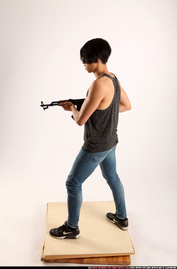 Man Young Athletic Fighting with submachine gun Standing poses Casual Asian