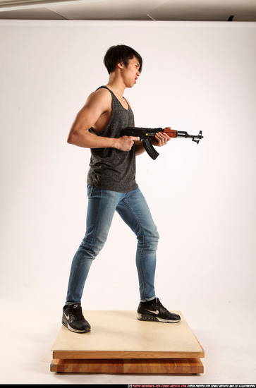 Man Young Athletic Fighting with submachine gun Standing poses Casual Asian