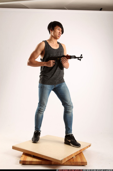 Man Young Athletic Fighting with submachine gun Standing poses Casual Asian