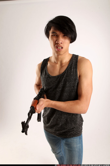 Man Young Athletic Fighting with submachine gun Standing poses Casual Asian