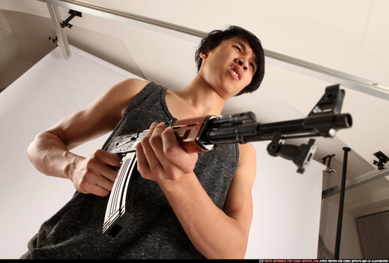 Man Young Athletic Fighting with submachine gun Standing poses Casual Asian