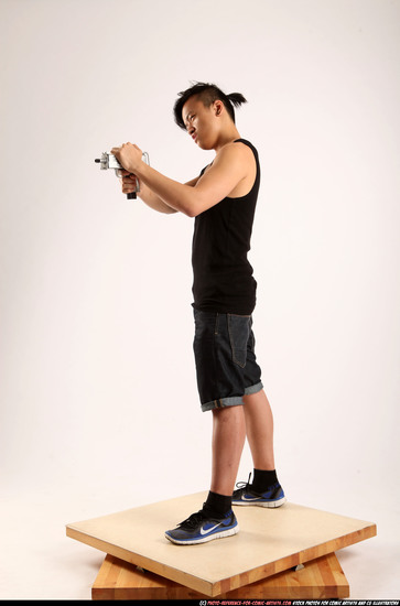 Man Young Athletic Fighting with submachine gun Standing poses Casual Asian