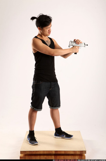 Man Young Athletic Fighting with submachine gun Standing poses Casual Asian