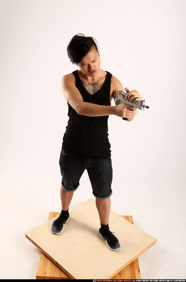 Man Young Athletic Fighting with submachine gun Standing poses Casual Asian