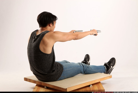 Man Young Athletic Fighting with gun Sitting poses Casual Latino