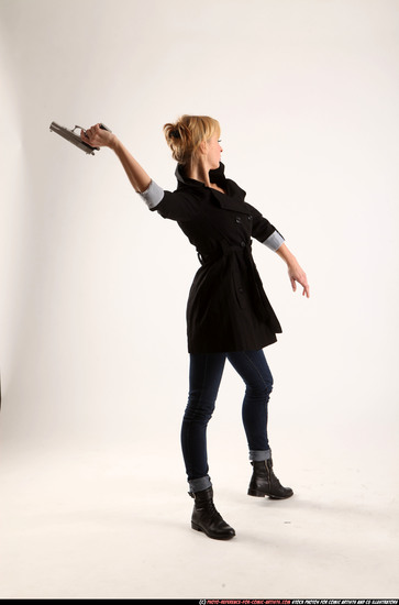 Woman Adult Athletic White Fighting with gun Standing poses Coat