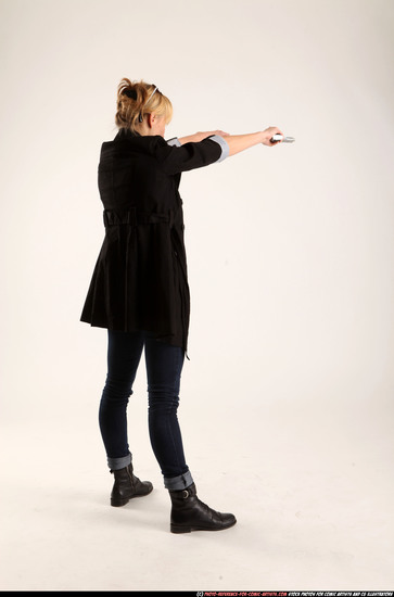 Woman Adult Athletic White Fighting with gun Standing poses Coat