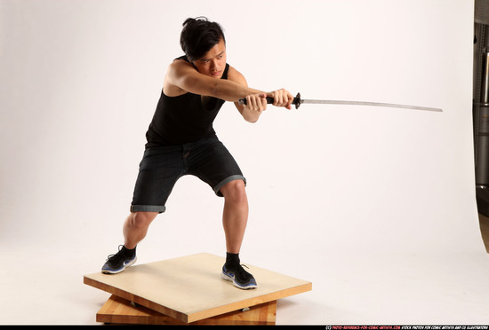 Man Young Athletic Fighting with sword Kneeling poses Sportswear Asian