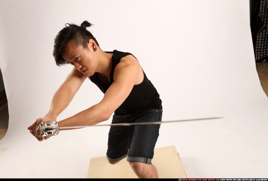 Man Young Athletic Fighting with sword Kneeling poses Sportswear Asian