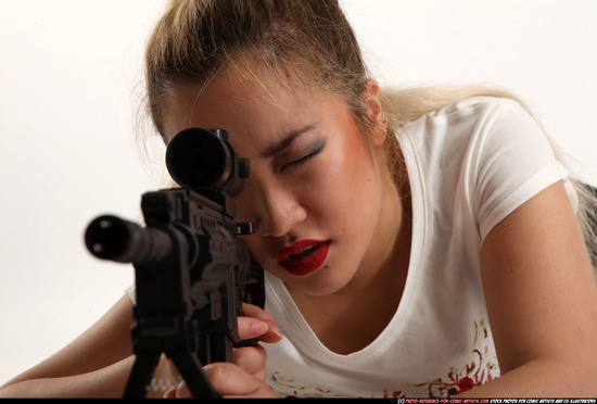 Woman Young Average Fighting with submachine gun Laying poses Casual Asian