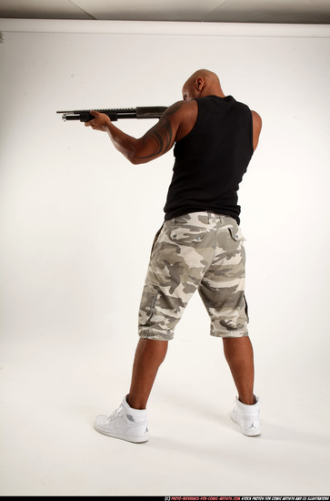 Man Adult Athletic Black Standing poses Sportswear Fighting with shotgun