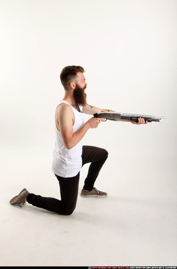 Man Adult Athletic White Kneeling poses Casual Fighting with shotgun