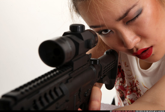 Woman Young Average Fighting with submachine gun Kneeling poses Casual Asian