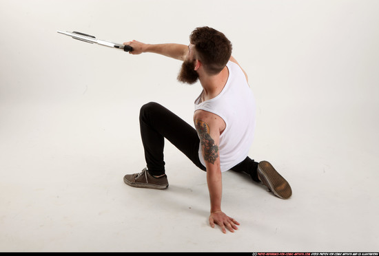 Man Adult Athletic White Kneeling poses Casual Fighting with shotgun