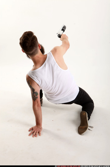 Man Adult Athletic White Kneeling poses Casual Fighting with shotgun