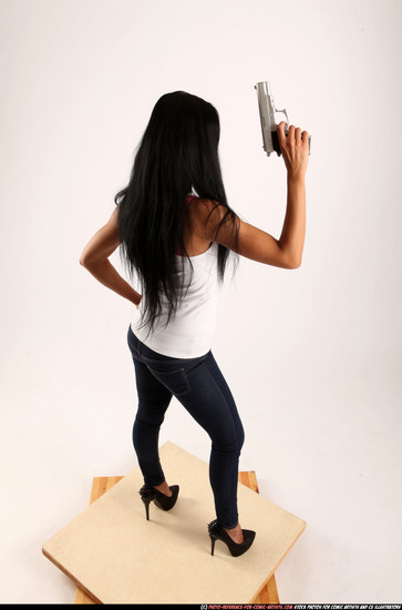 Woman Young Athletic Fighting with gun Standing poses Casual Latino