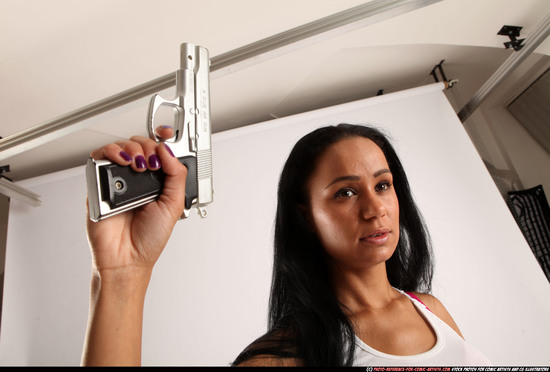 Woman Young Athletic Fighting with gun Standing poses Casual Latino