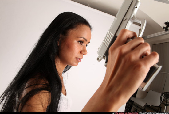 Woman Young Athletic Fighting with gun Standing poses Casual Latino