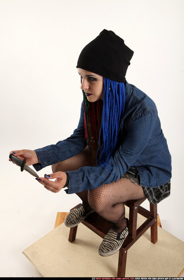 Woman Young Average White Fighting with knife Sitting poses Casual