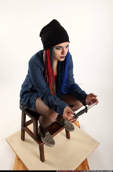 Woman Young Average White Fighting with knife Sitting poses Casual