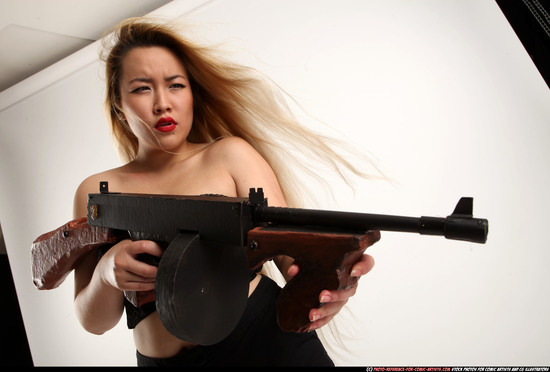 Woman Young Average Fighting with submachine gun Standing poses Casual Asian