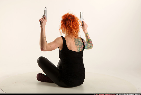 Woman Adult Athletic White Fighting with gun Sitting poses Casual