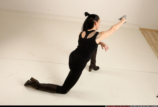 Woman Adult Athletic White Fighting with gun Kneeling poses Casual