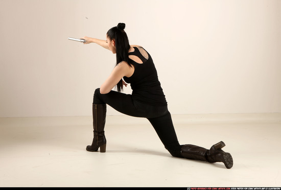 Woman Adult Athletic White Fighting with gun Kneeling poses Casual