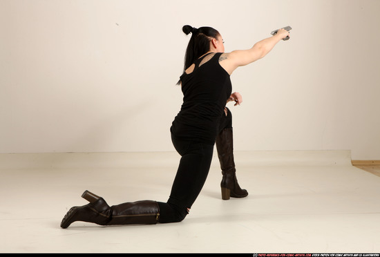 Woman Adult Athletic White Fighting with gun Kneeling poses Casual