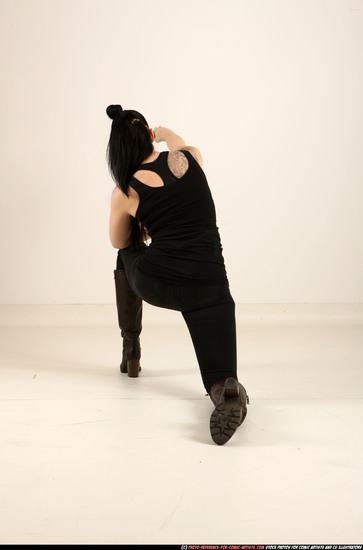 Woman Adult Athletic White Fighting with gun Kneeling poses Casual