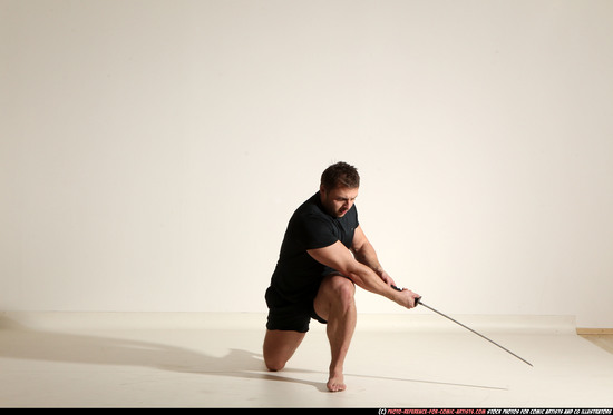 Man Adult Muscular White Fighting with sword Kneeling poses Sportswear