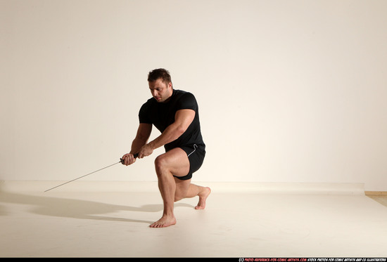 Man Adult Muscular White Fighting with sword Kneeling poses Sportswear