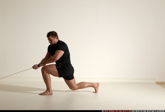 Man Adult Muscular White Fighting with sword Kneeling poses Sportswear