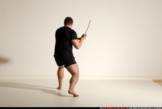 Man Adult Muscular White Fighting with sword Kneeling poses Sportswear