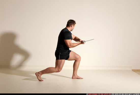 Man Adult Muscular White Fighting with sword Kneeling poses Sportswear