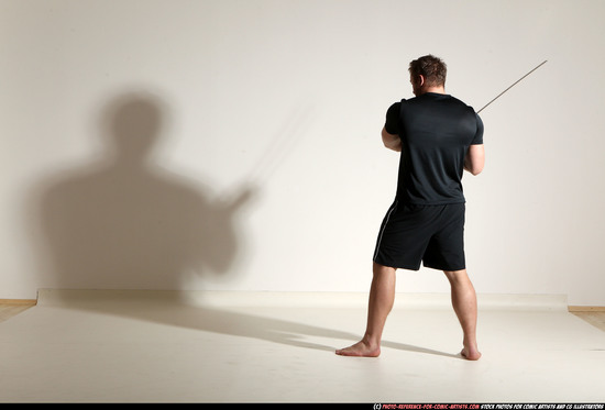 Man Adult Muscular White Fighting with sword Kneeling poses Sportswear