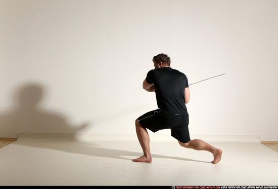 Man Adult Muscular White Fighting with sword Kneeling poses Sportswear