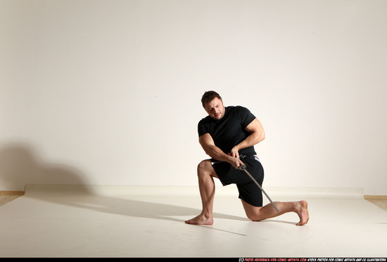 Man Adult Muscular White Fighting with sword Kneeling poses Sportswear