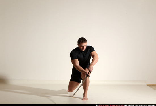 Man Adult Muscular White Fighting with sword Kneeling poses Sportswear