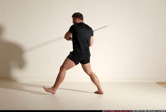 Man Adult Muscular White Fighting with sword Kneeling poses Sportswear