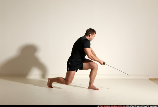 Man Adult Muscular White Fighting with sword Kneeling poses Sportswear